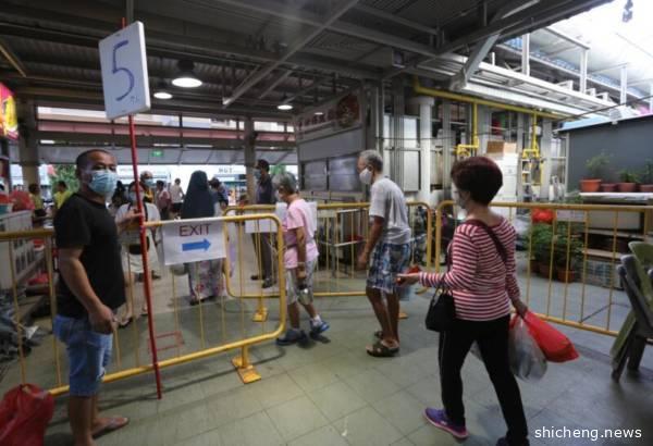 限制进入巴刹的人潮 狮城环境局人员在场监督