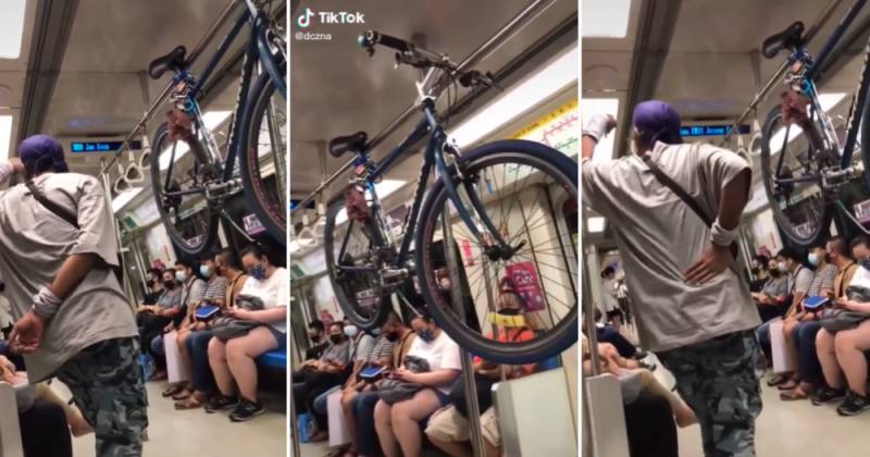 本地男子带自行车上地铁，把整部车挂在扶手横杆上，竟还爆粗口